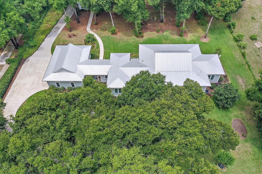 Aerial of Home with Metal Roof and Trees Adding Privacy and Shade