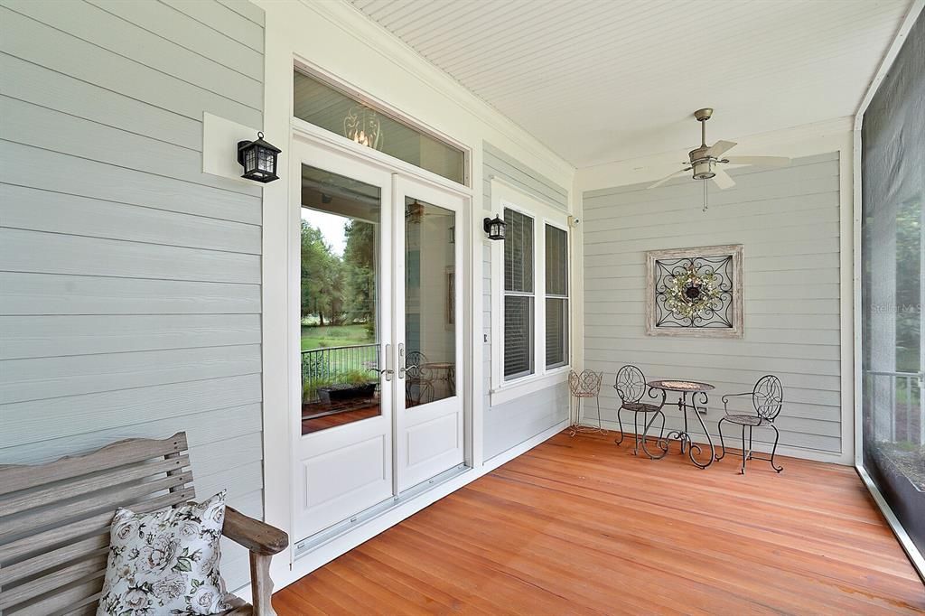 Front Porch with Pine Wood Floors and Double Door Entry