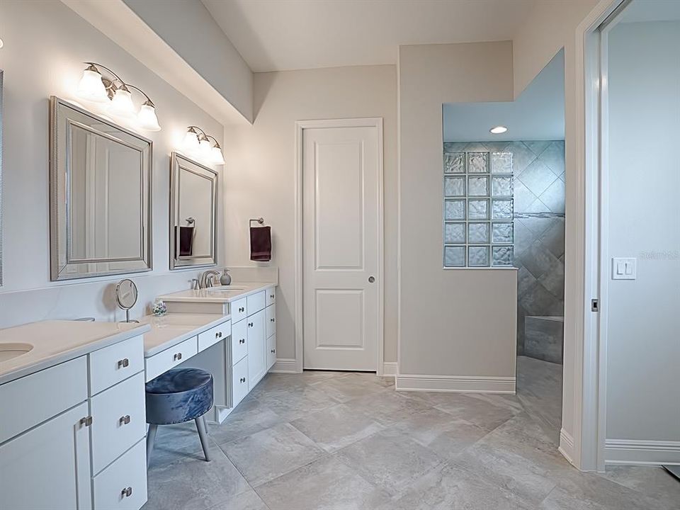 LOVELY MASTER BATH WITH GRANITE COUNTERS, CUSTOM MIRRORS, OVERSIZED LINEN CLOSET BEHIND CLOSED DOOR AND ROMAN SHOWER!  SEPARATE TOILET ROOM TO THE RIGHT.