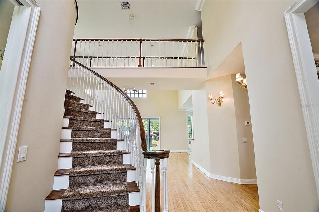grand spiral staircase at entrance of home