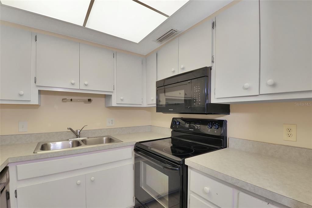 The kitchen boasts ample cabinetry for your culinary needs