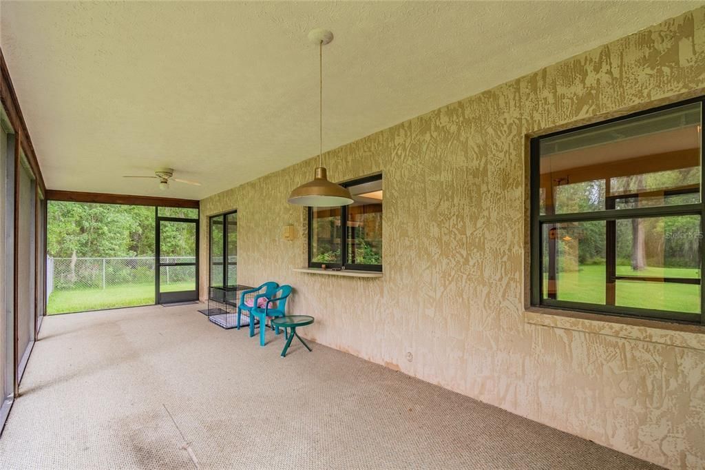 Large Screened Lanai off Dining Area with Pass-Through Window to Kitchen