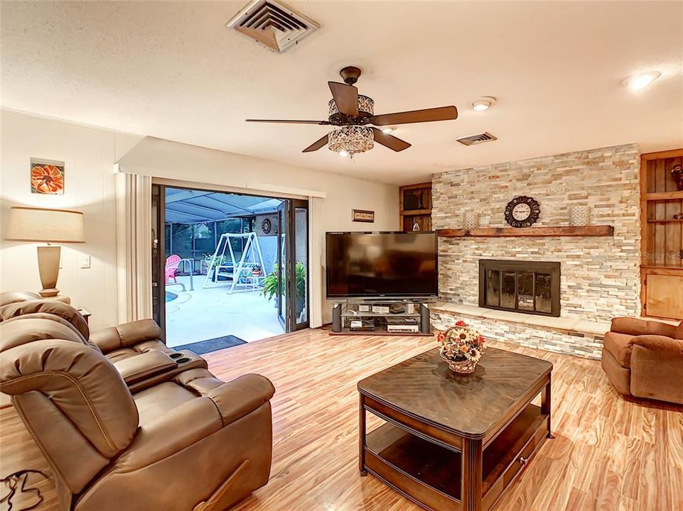 The family room boasts a wood burning fireplace with built-in bookcases on either side.