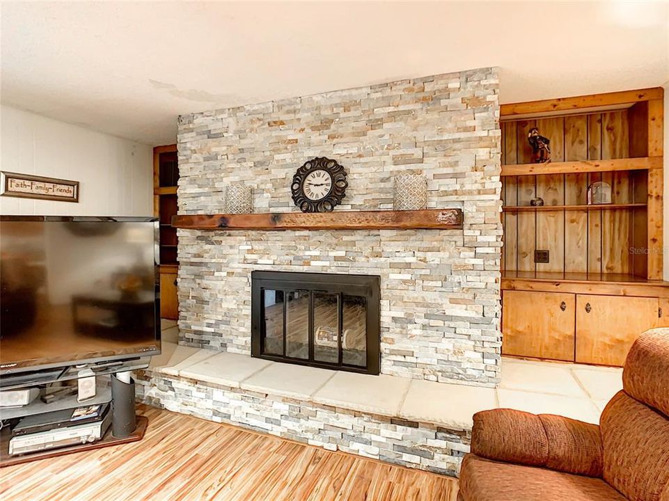 Beautiful brick feature wall shows off the wood burning fireplace.