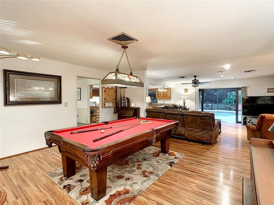 The living room opens to the family room and is currently used as a game room.