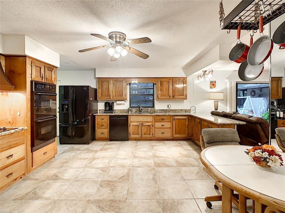 The kitchen has been remodeled with granite counters, ceramic tile flooring, solid maple wood cabinetry, and a window over the kitchen sink provides a great back yard view.