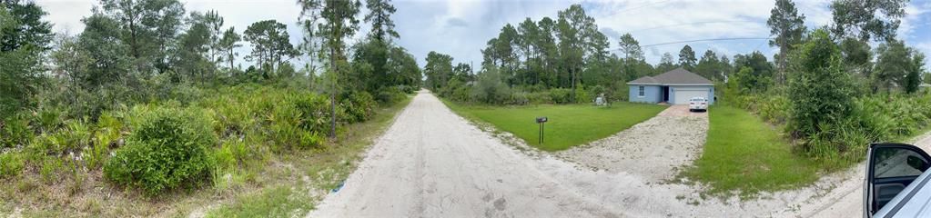 PANO OF THE ROAD.  LOT IS ON THE LEFT AND NEIGHBOR TO THE RIGHT