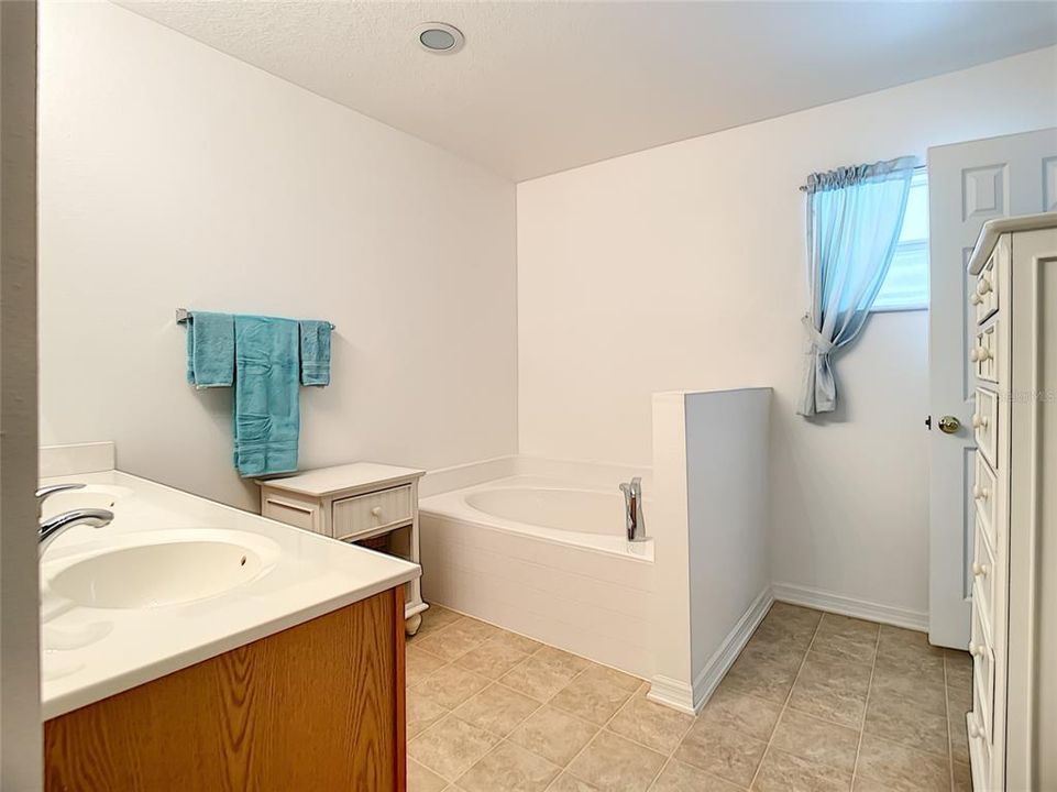 Master bath has dual sinks, garden tub and walk-in shower.