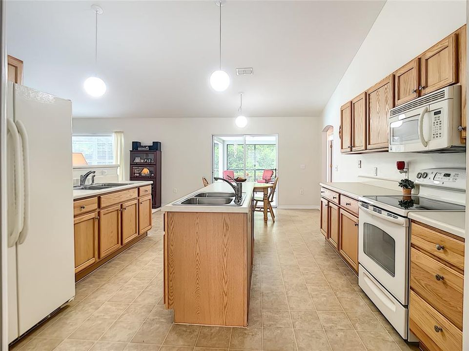 This kitchen provides plenty of drawers, cabinets and counter top work space.