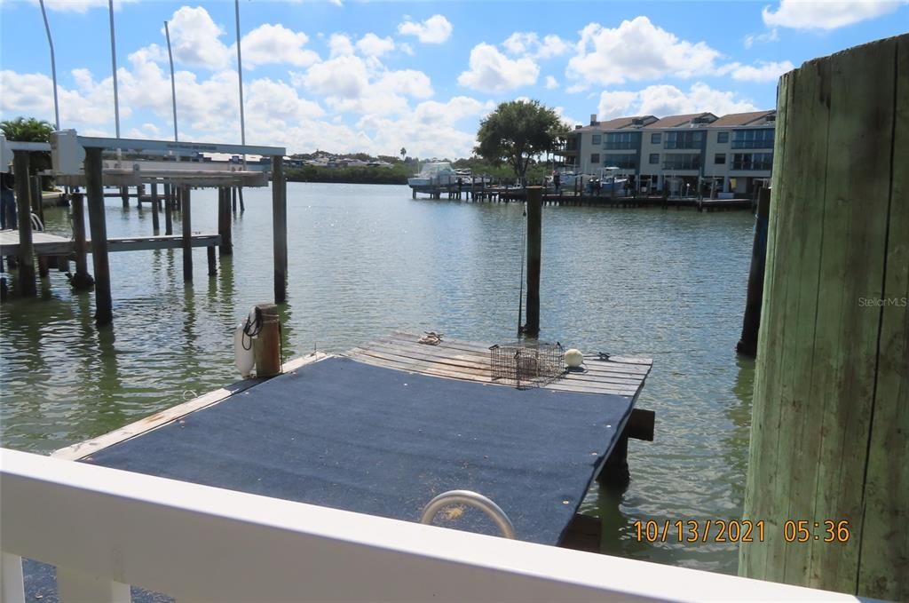 Rear view, looking southeast toward the Intracoastal Waterway. Dock with a lower landing and tie poles