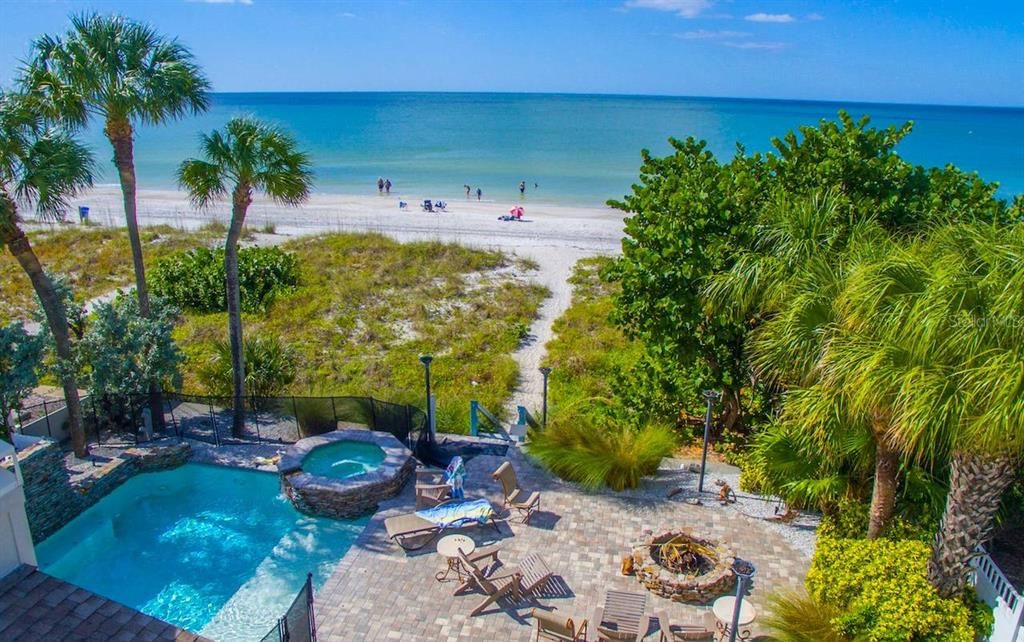 Aerial of gulfside, beach, patio, pool and spa