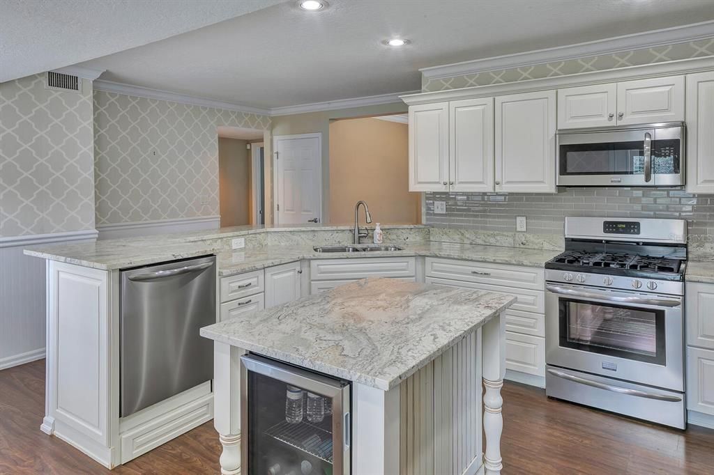 Newly remodeled kitchen with gas stove and stainless appliances