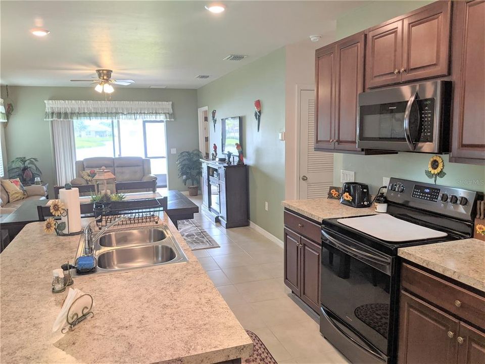 the kitchen is spacious, with wood cabinets, and upgraded appliances