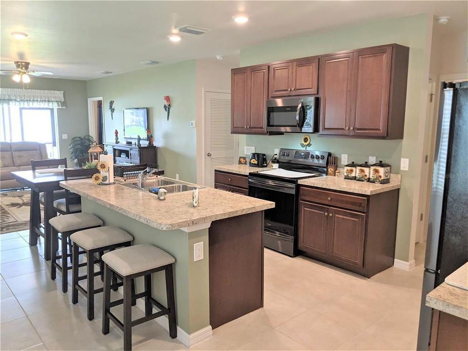 from the foyer enter in the living area with great open kitchen with breakfast bar.