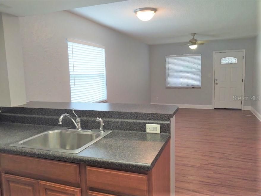 View of living room and entry from kitchen