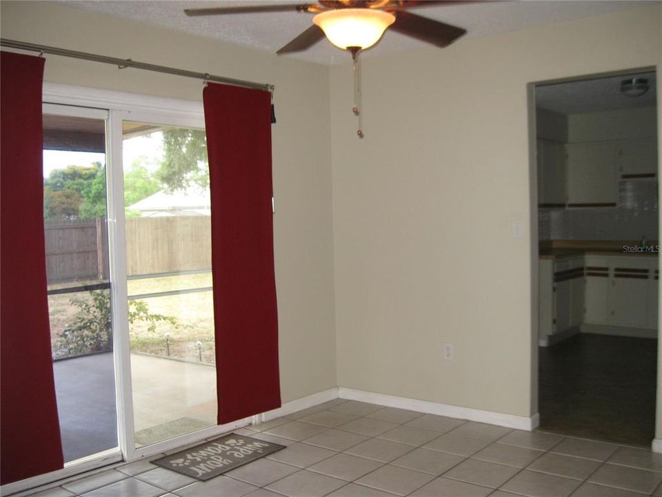 ANOTHER VIEW OF DINING ROOM SHOWING SCREENED LANAI, BKYD, KITCHEN.