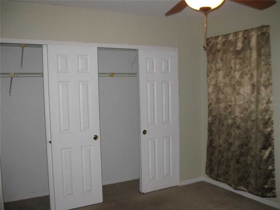 MASTER BEDROOM HAS DOUBLE CLOSET, CEILING FAN/LIGHT AND CARPET.