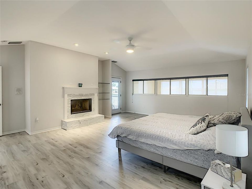Master bedroom with fireplace and large balcony