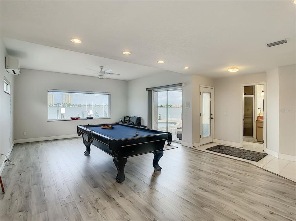 Game room with full bath.  If one ever needed a downstairs master, it is sizable enough to convert to a master bedroom. Now makes a perfect pool bath.