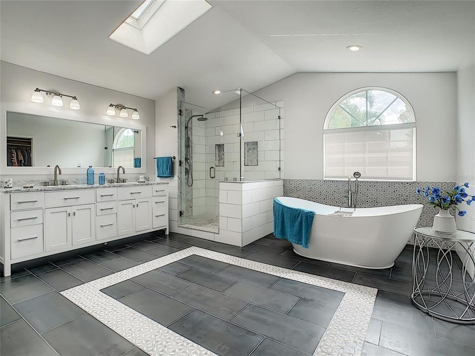 Double  sink vanity, soaking beautiful shower, soaking tub and a large dressing area.