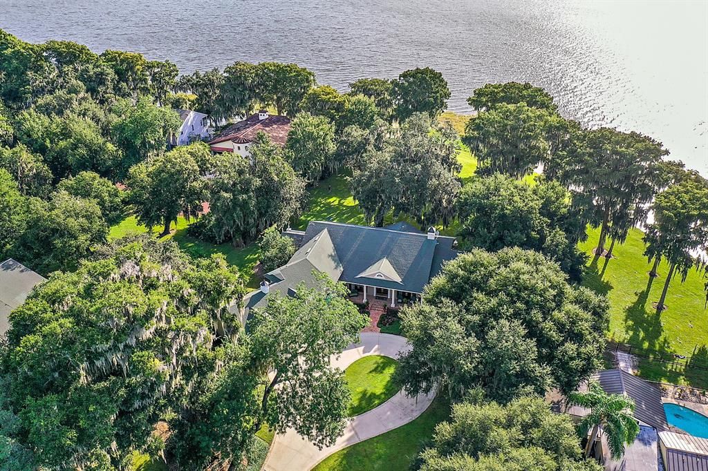 Magnificent 1.44 acre, custom lakefront estate on Little Lake Harris with 3 BR, 4 BA, media room and 3-car garage.