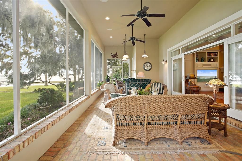 Panoramic lake views beckoning you to the expansive lanai with Chicago brick, ceiling fans, tiled bar/sink and adjoining sun patio perfect for grilling.