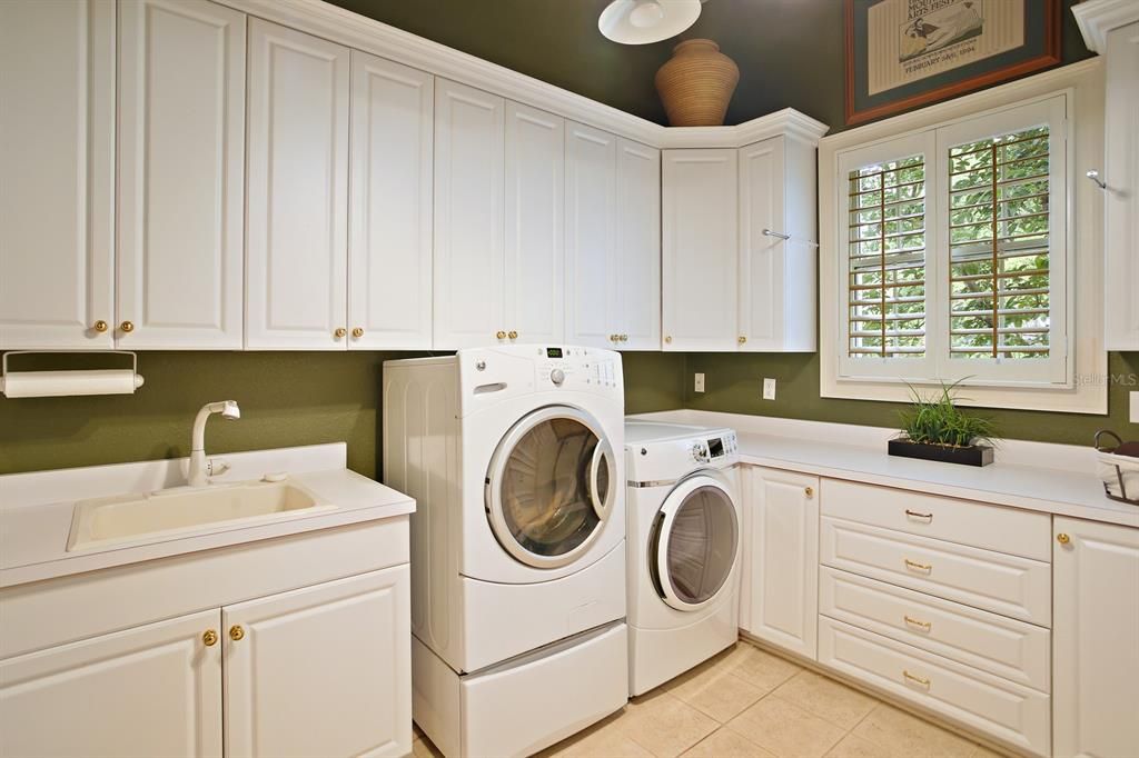 Laundry room with sink and cabinetry