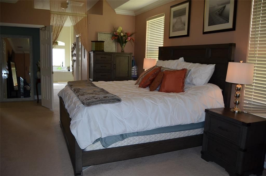 Master bedroom looking toward hallway to closets and en suite bathroom.