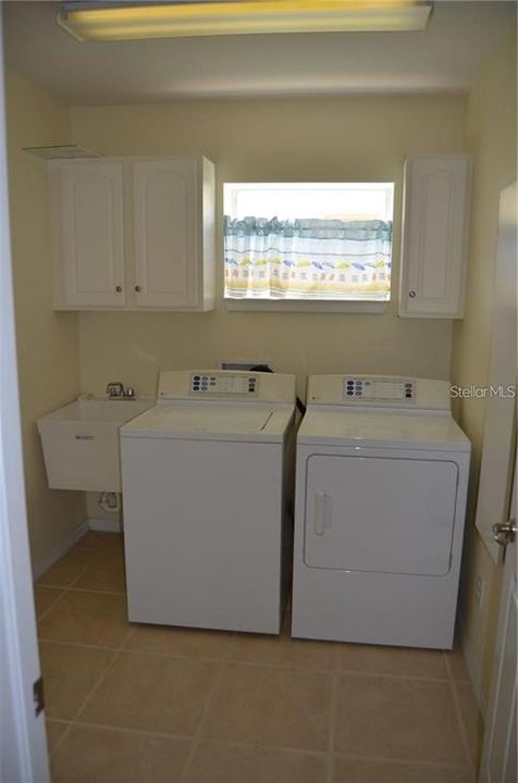 Laundry room of of the kitchen has utility sink and large under the stairs storage closet.