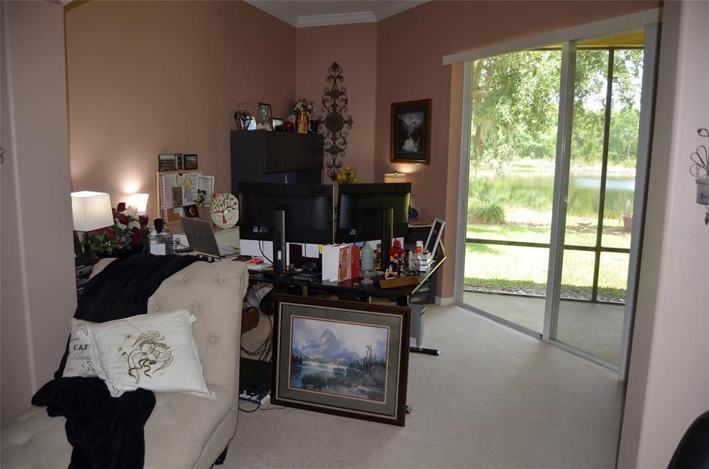 Sitting room off of master bedroom currently a home office - sliders to patio and view of lake.