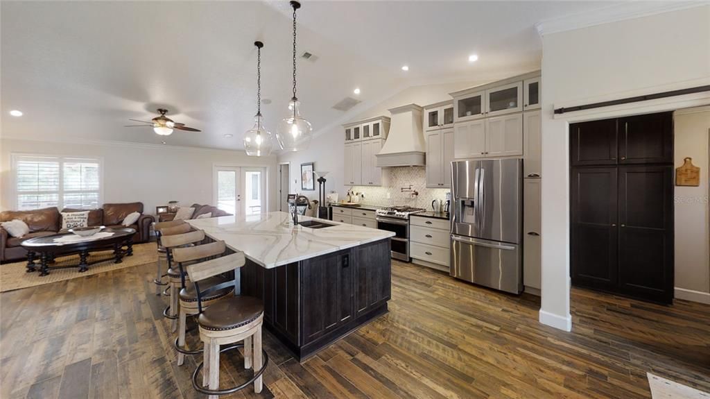 Great Room with large kitchen island as centerpiece.