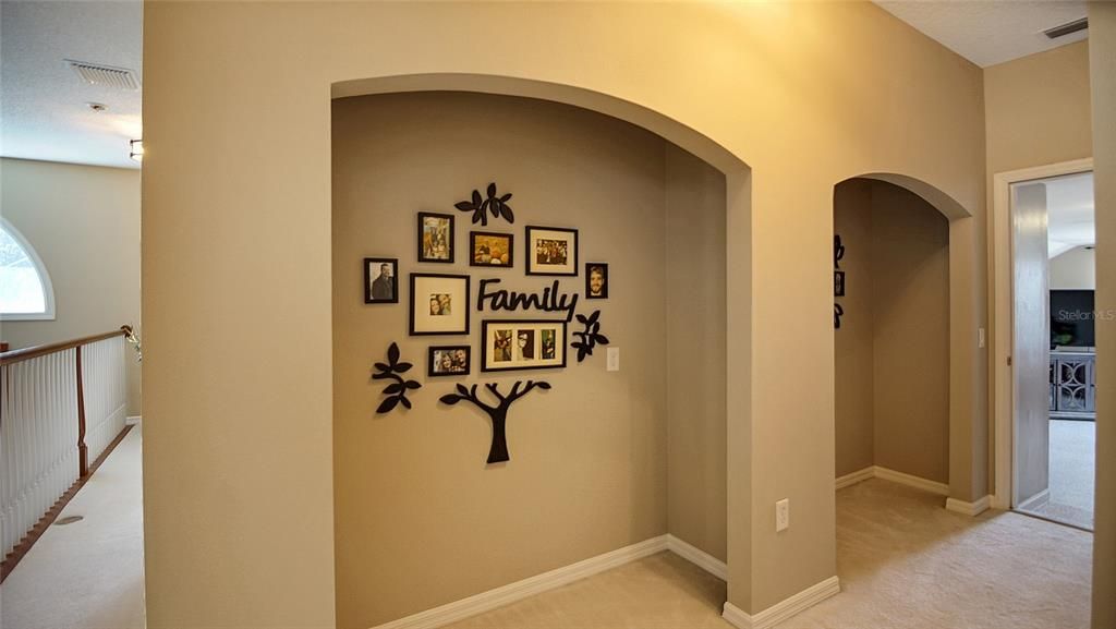The hallway from staircase to bedroom #4 has two wonderful nooks for photos or art displays.