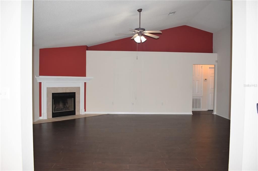 Family Room with Vaulted Ceilings and Wood Chimney
