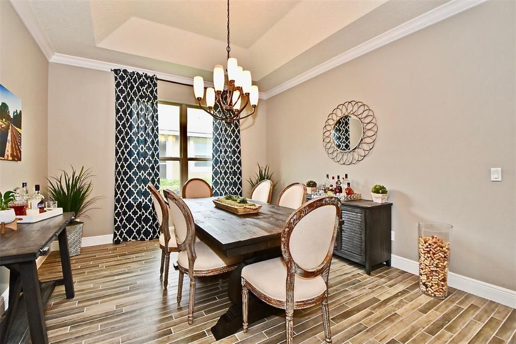 The formal dining room boasts tray ceilings.