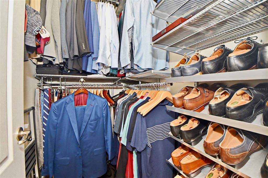 His large walk in closet with custom closet built-ins.