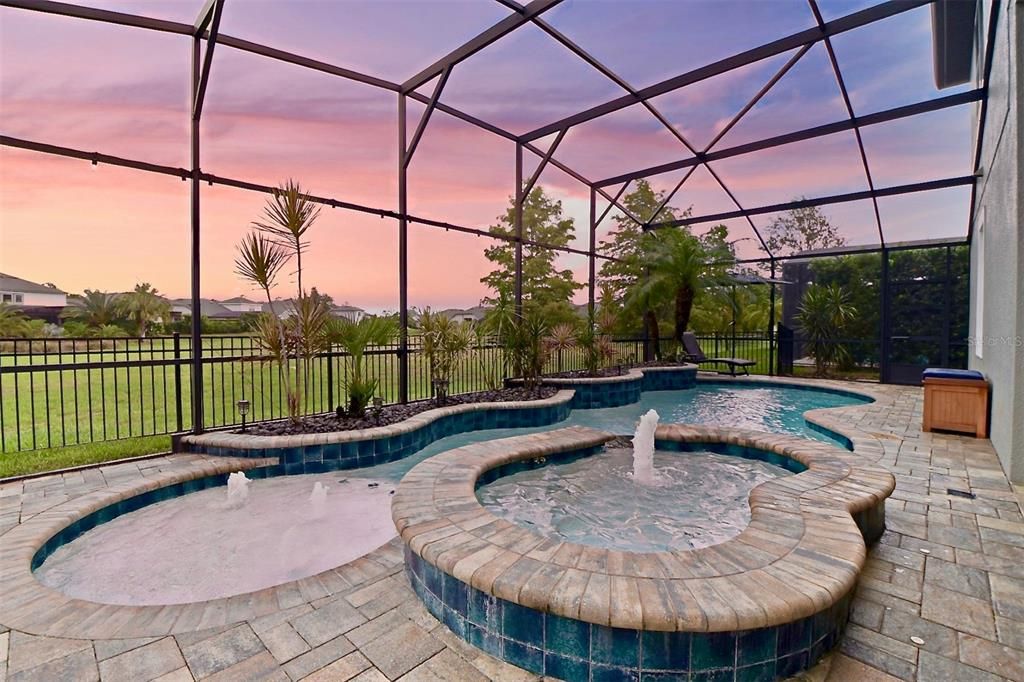 Custom Pool & Spa equipped with Water Features, Gas Heater,Floor Cleaning System and large fenced in backyard.