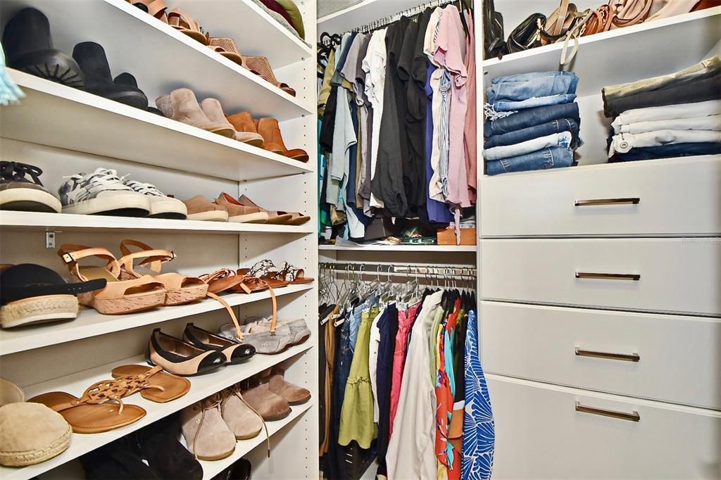 Her large walk in closet with custom closet built-ins.
