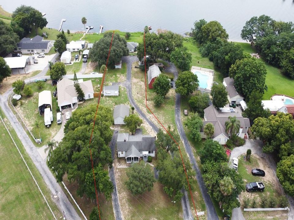 Aerial View showing house, detached garage, efficiency cottage, duplex, Lake Woodward frontage.