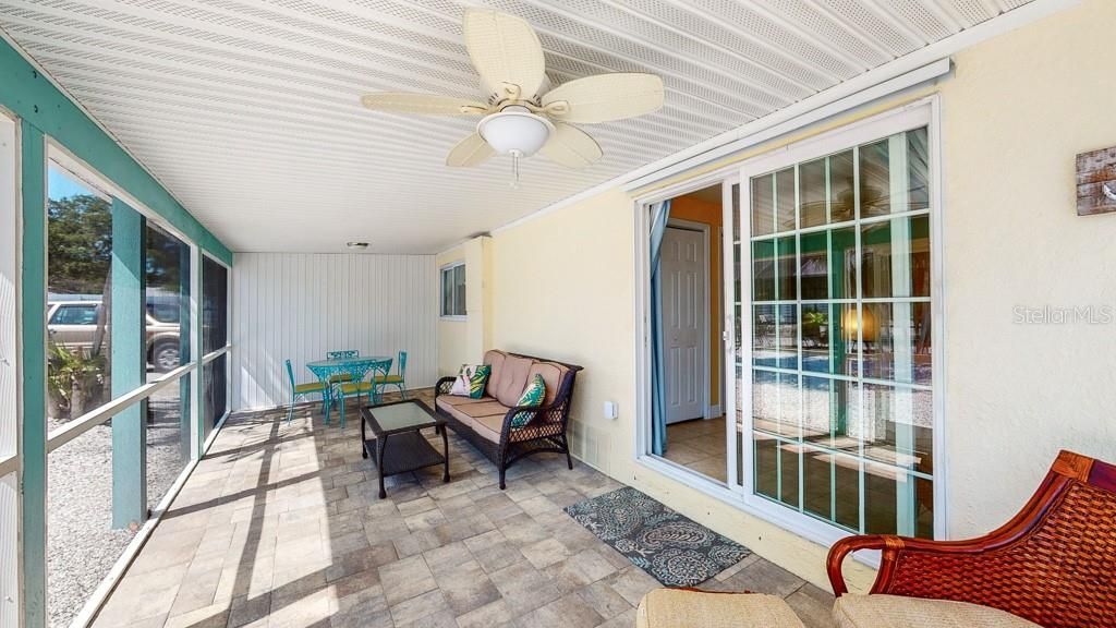 Flamingo: private screened lanai with pavered floor and ceiling fan.