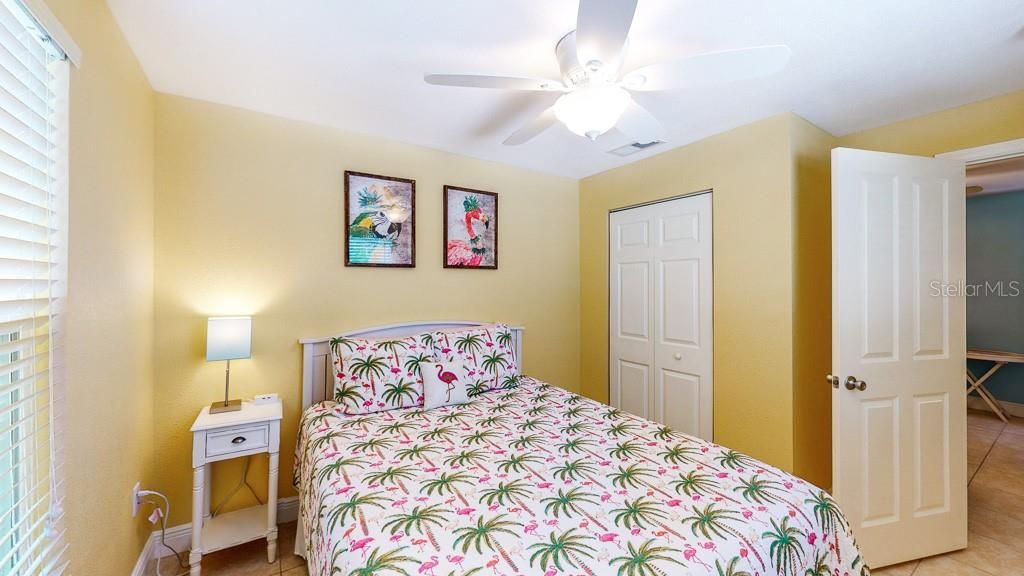 Flamingo: queen sized bed with closet and ceiling fan.