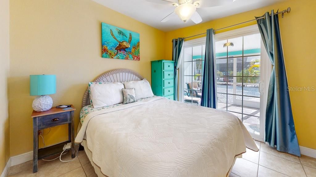 Sea Turtle: queen size bed, tile floors and sliding doors to the outdoor lanai.