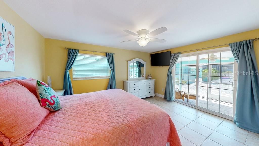 Flamingo: 2nd bedroom with tile floors and sliding doors to a large screened lanai.