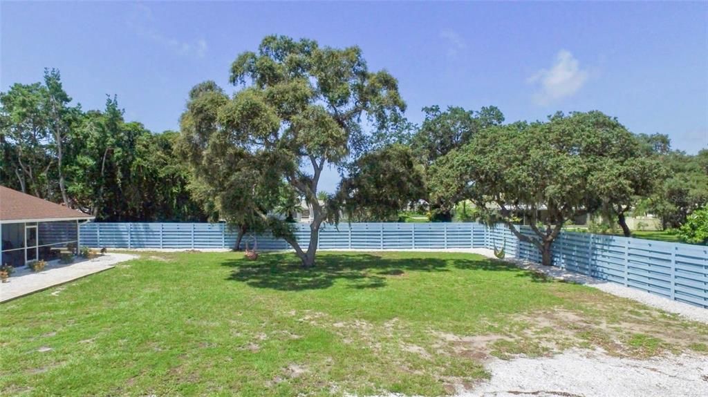 Multifamily vacant lot is fenced on 2 sides to create privacy and make the rentals feel like a mini resort.
