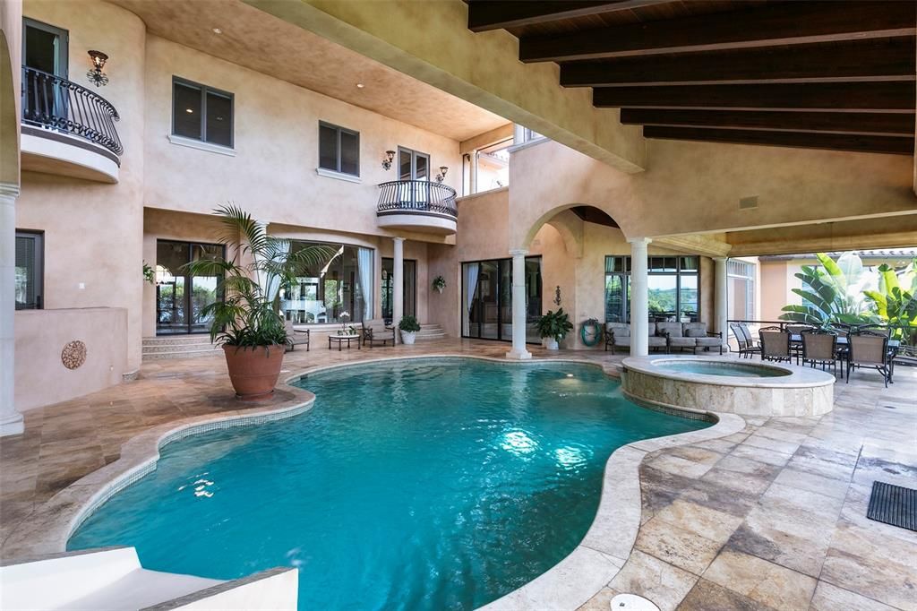 Massive teak wood beams grace the ceiling and highlight architectural features of the lanai.