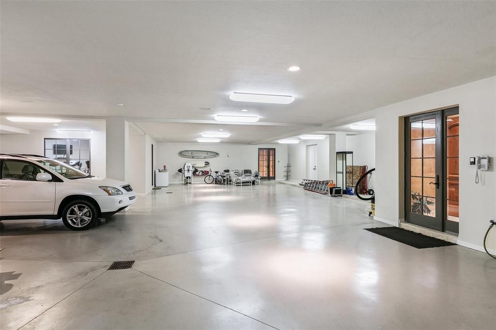 The expansive garage offers several air-conditioned storage rooms, space for more than five vehicles and a third laundry area.