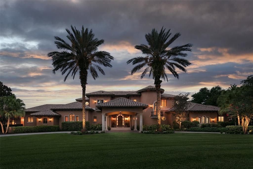 This sprawling estate spans more than 11,000 square feet along the shores of Lake Bessie.