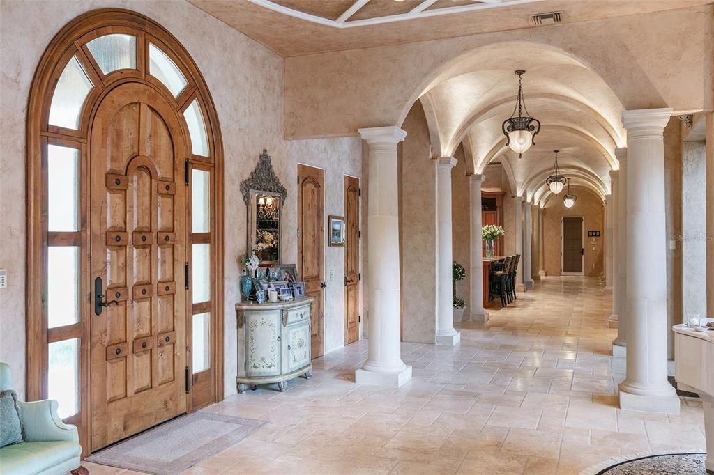 Exquisite finishes adorn the grand foyer, from stone columns and travertine floors to a series of groin vaults along the ceiling.