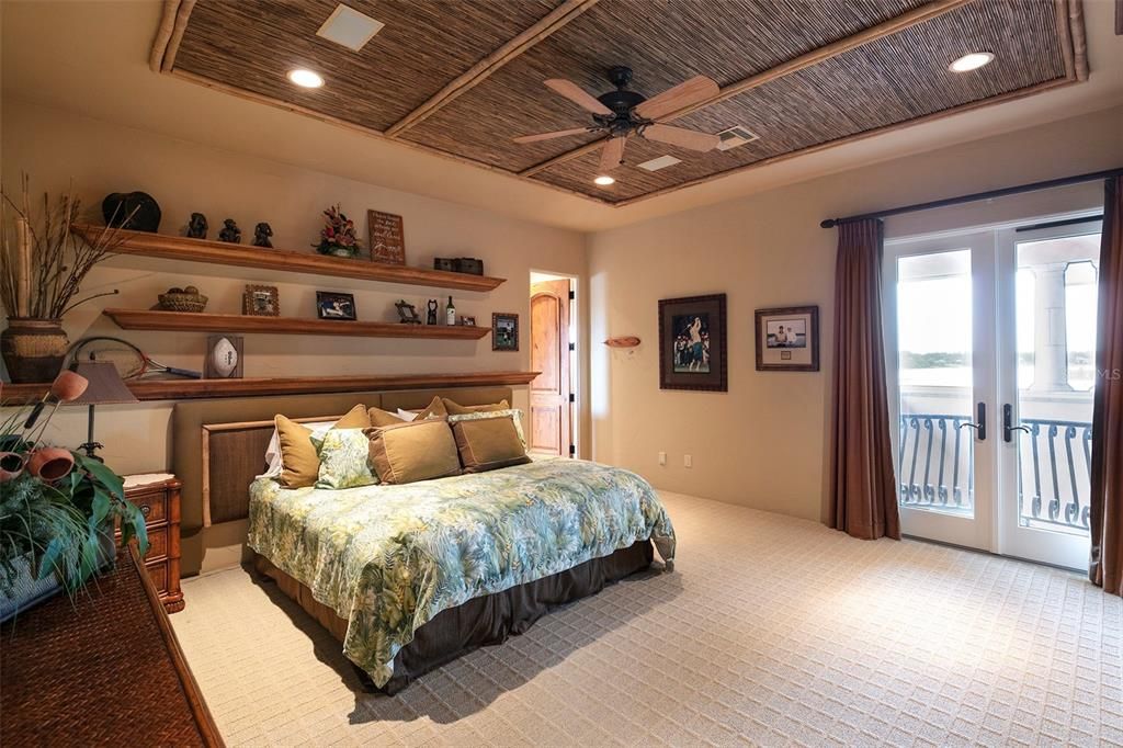 Bedroom suite #3 features a walk-in closet, custom built-in shelving and a Juliet balcony overlooking the pool.