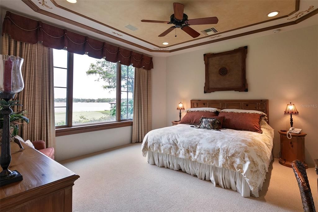 The guest apartment's private bedroom offers lush green views of the lawn out towards Lake Bessie.