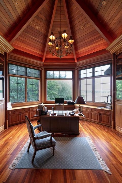 The private office features custom wood cabinetry paired with beautiful teak ceiling.